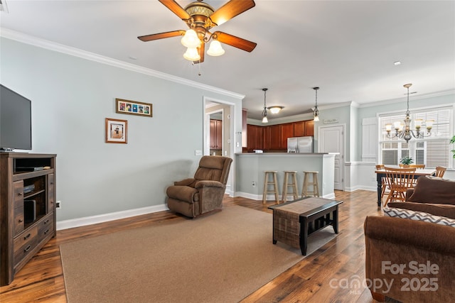 9113 Cinder Ln, Huntersville, NC 28078 - living area featuring ceiling fan with notable chandelier, crown molding, baseboards, and wood finished floors