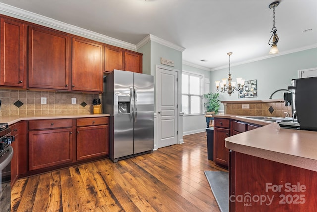 9113 Cinder Ln, Huntersville, NC 28078 - kitchen with stainless steel fridge, crown molding, dark wood finished floors, hanging light fixtures, and a notable chandelier