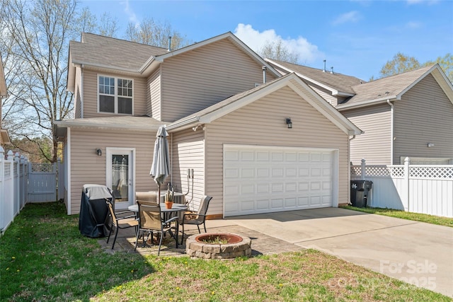 9113 Cinder Ln, Huntersville, NC 28078 - rear view of property with a patio area, concrete driveway, an outdoor fire pit, fence, and a garage