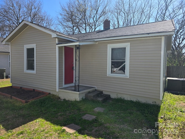 325 Orr Dr, Rock Hill, SC 29730 - view of front of house featuring a chimney, fence, a front lawn, and roof with shingles
