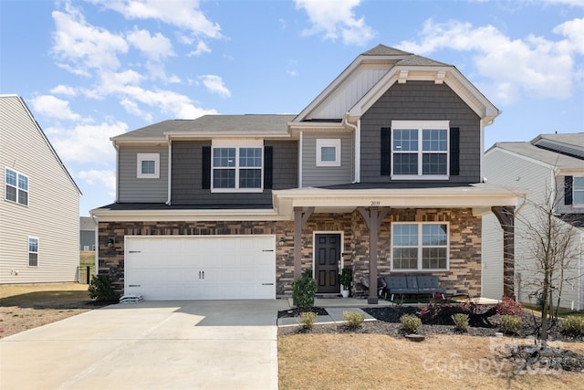 craftsman inspired home with an attached garage, a porch, stone siding, and concrete driveway