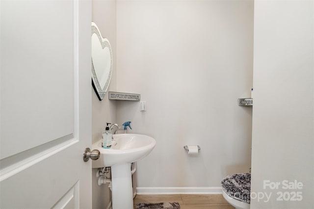 half bathroom with baseboards