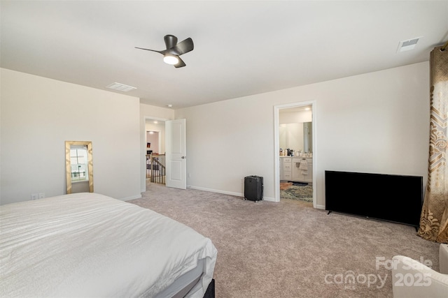 carpeted bedroom featuring baseboards, visible vents, ceiling fan, and ensuite bath