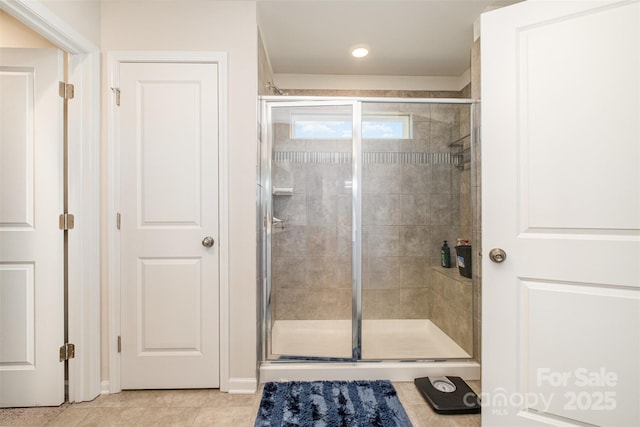 full bath with a stall shower and tile patterned flooring