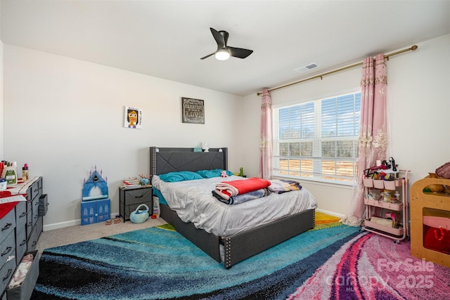 carpeted bedroom featuring baseboards, visible vents, and a ceiling fan