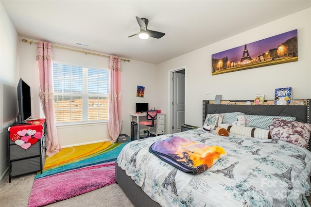 carpeted bedroom with baseboards, visible vents, and a ceiling fan