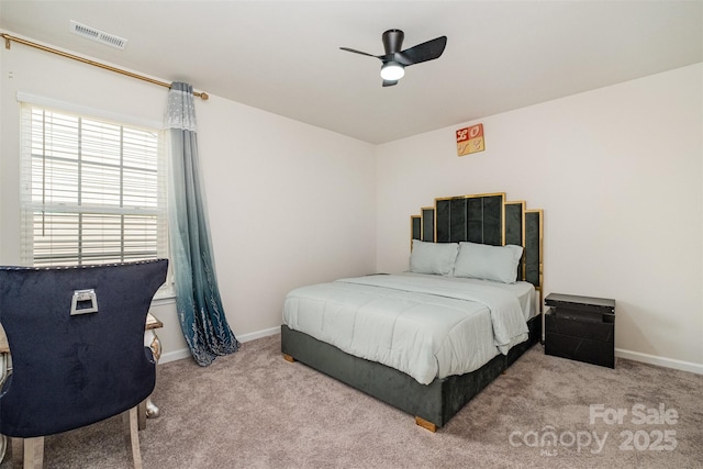 bedroom with baseboards, carpet floors, visible vents, and a ceiling fan