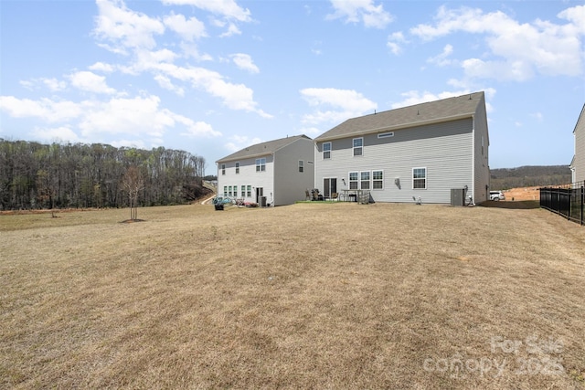 rear view of house featuring a yard
