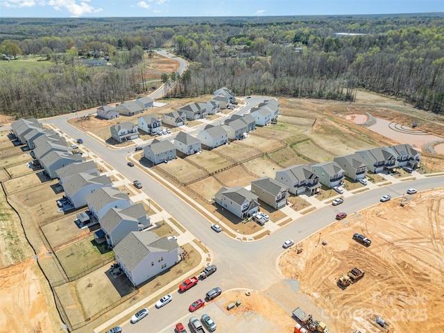 birds eye view of property with a view of trees and a residential view