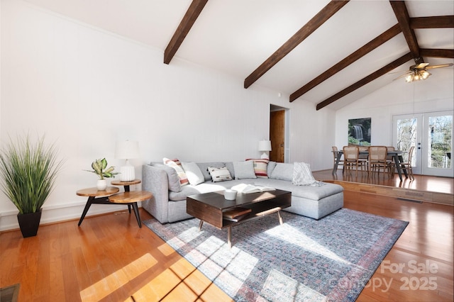 living area featuring beam ceiling, french doors, light wood-type flooring, visible vents, and ceiling fan