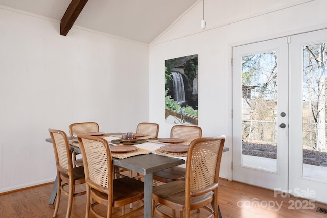 dining room with vaulted ceiling with beams, visible vents, french doors, and light wood-type flooring