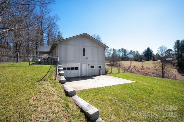 view of home's exterior featuring fence, a yard, and an attached garage