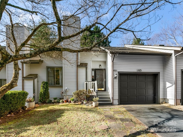 103 Cimarron Dr, Asheville, NC 28803 - view of front of home with driveway, a chimney, and an attached garage
