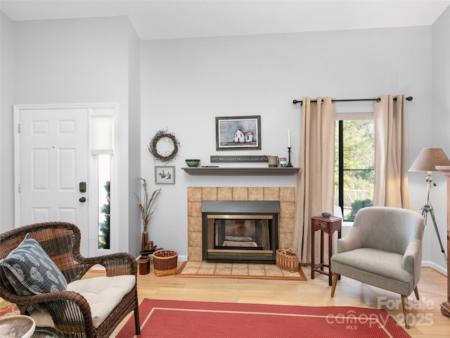 103 Cimarron Dr, Asheville, NC 28803 - living room featuring a tiled fireplace, baseboards, and wood finished floors