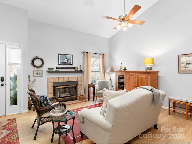 103 Cimarron Dr, Asheville, NC 28803 - living room featuring high vaulted ceiling, a fireplace, baseboards, light wood-style floors, and ceiling fan