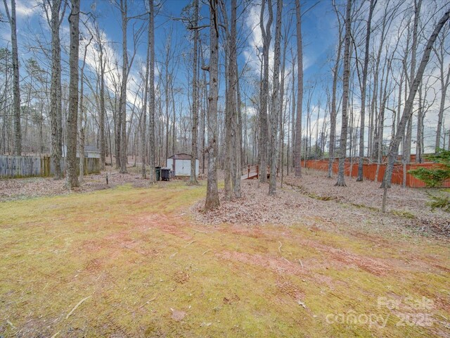1312 Kensington Pl, Monroe, NC 28112 - view of yard featuring fence, an outdoor structure, and a shed