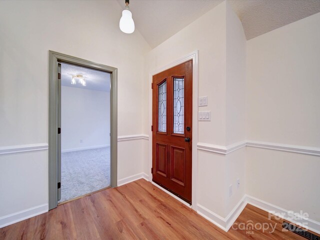 1312 Kensington Pl, Monroe, NC 28112 - entrance foyer with baseboards, lofted ceiling, and light wood-type flooring