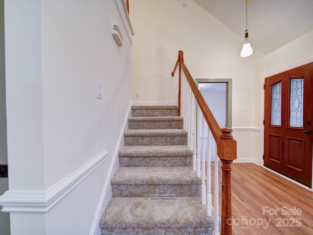 1312 Kensington Pl, Monroe, NC 28112 - stairs featuring baseboards, vaulted ceiling, and wood finished floors