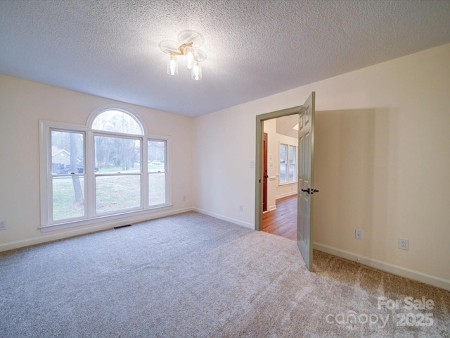 1312 Kensington Pl, Monroe, NC 28112 - empty room featuring baseboards, carpet flooring, a textured ceiling, and visible vents