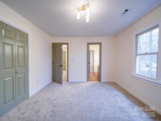 1312 Kensington Pl, Monroe, NC 28112 - carpeted bedroom featuring baseboards, a textured ceiling, and visible vents