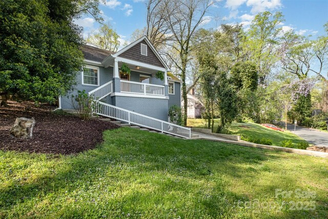 view of front of house featuring a front lawn and covered porch