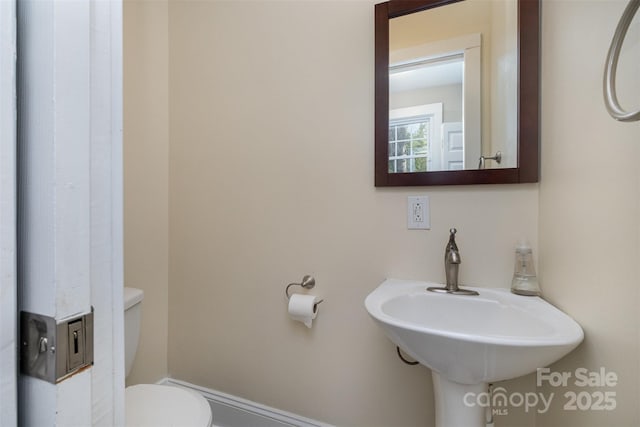 half bath featuring toilet