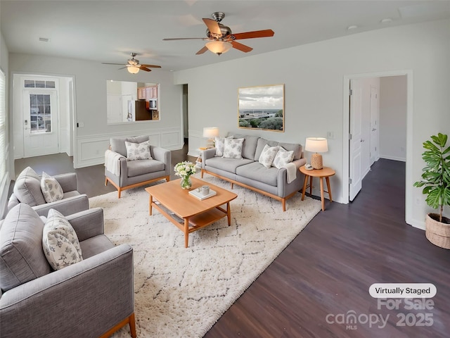 living area with ceiling fan and wood finished floors