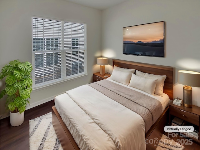 bedroom with baseboards and wood finished floors