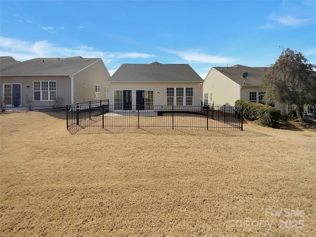 rear view of property with fence and a patio area