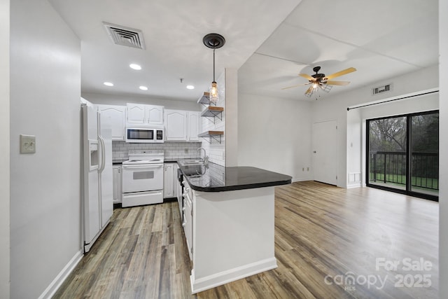 211 Heritage Blvd Unit 301, Fort Mill, SC 29715 - kitchen featuring visible vents, dark countertops, a peninsula, and white appliances