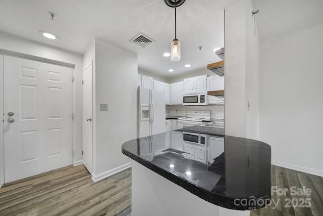 211 Heritage Blvd Unit 301, Fort Mill, SC 29715 - kitchen featuring white appliances, dark countertops, visible vents, white cabinets, and wood finished floors