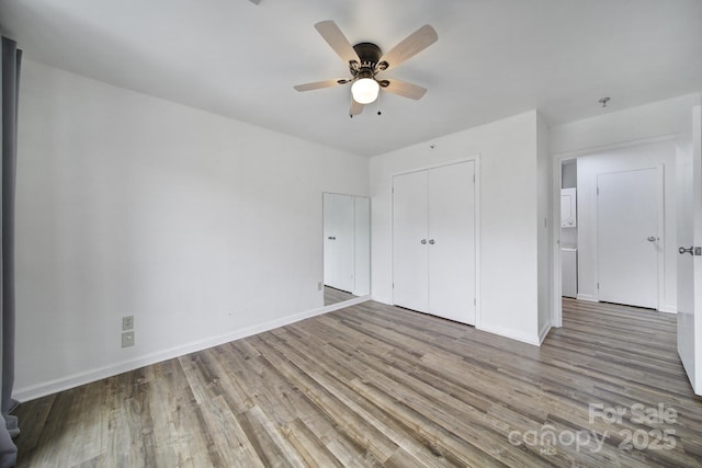 211 Heritage Blvd Unit 301, Fort Mill, SC 29715 - unfurnished bedroom with baseboards, wood finished floors, a closet, and a ceiling fan