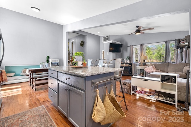 3407 14th Ave SW, Hickory, NC 28602 - kitchen featuring gray cabinetry, light wood-type flooring, ceiling fan, a kitchen island, and open floor plan