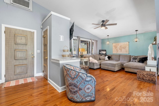 3407 14th Ave SW, Hickory, NC 28602 - living area featuring wood finished floors, ceiling fan, and vaulted ceiling