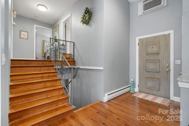 3407 14th Ave SW, Hickory, NC 28602 - entrance foyer featuring baseboard heating, wood finished floors, and stairway