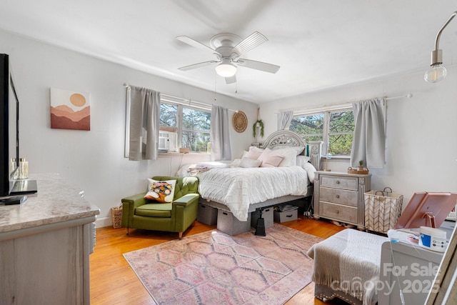 3407 14th Ave SW, Hickory, NC 28602 - bedroom featuring multiple windows, light wood finished floors, and a ceiling fan