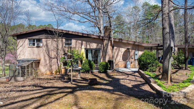 3407 14th Ave SW, Hickory, NC 28602 - rear view of property with a greenhouse, brick siding, and a chimney