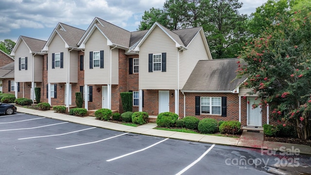 2222 15th Ave NE Unit 505, Hickory, NC 28601 - view of front of house featuring roof with shingles, uncovered parking, and brick siding