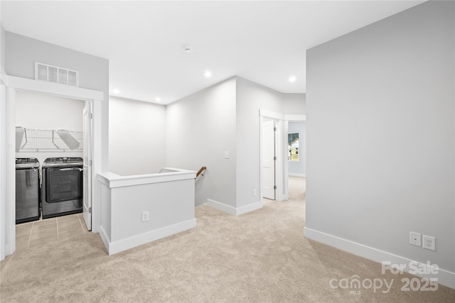 corridor featuring an upstairs landing, recessed lighting, independent washer and dryer, visible vents, and light carpet