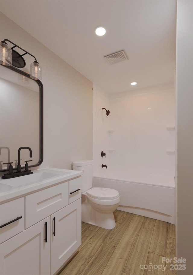 4969 Fitzgerald Ave, Charlotte, NC 28213 - full bathroom with wood finished floors, vanity, toilet, tub / shower combination, and recessed lighting