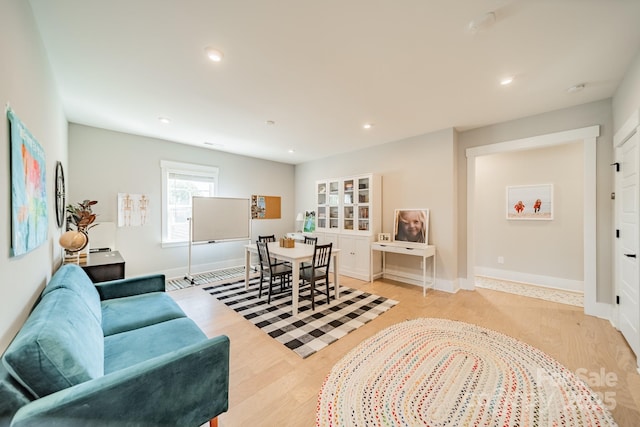 interior space with light wood-type flooring, baseboards, and recessed lighting