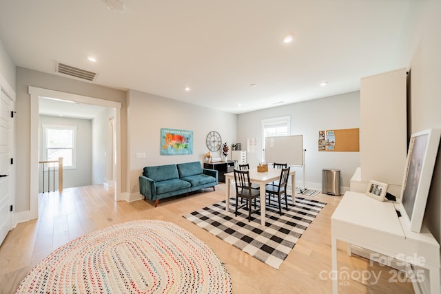 living room with recessed lighting, visible vents, light wood-style floors, and plenty of natural light