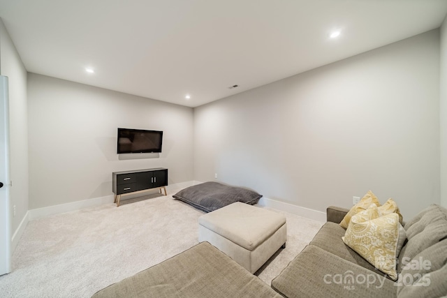 living area featuring baseboards, recessed lighting, and carpet