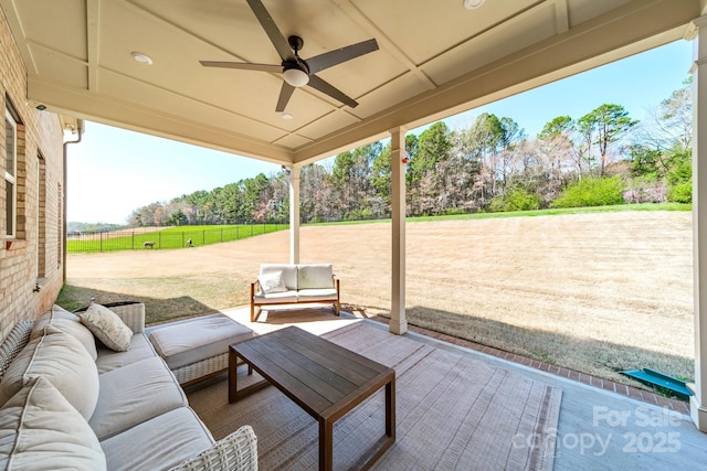 view of patio / terrace featuring outdoor lounge area, ceiling fan, and fence