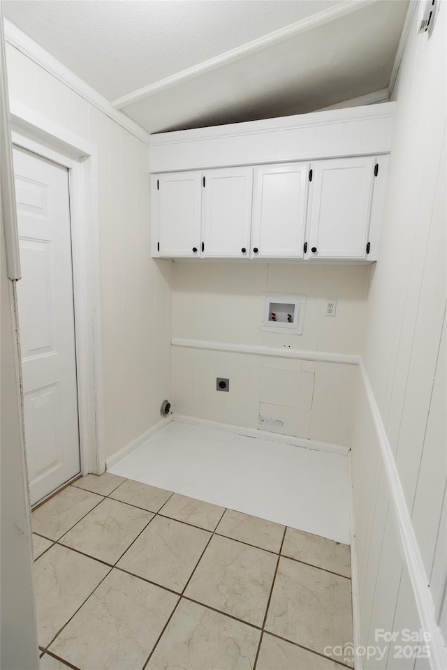 clothes washing area featuring light tile patterned floors, hookup for a washing machine, electric dryer hookup, and cabinet space
