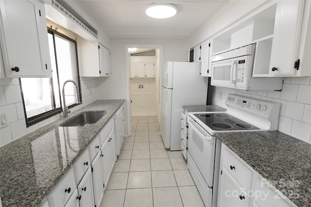 kitchen featuring decorative backsplash, white cabinetry, a sink, and white appliances