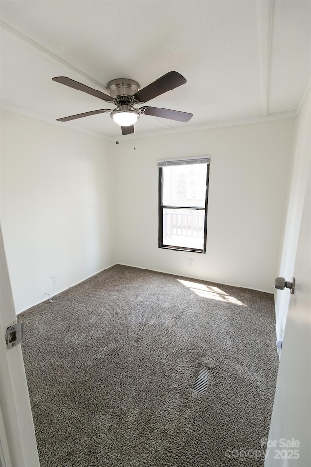 carpeted spare room with ceiling fan