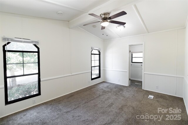 carpeted empty room with lofted ceiling with beams, visible vents, a decorative wall, and a ceiling fan