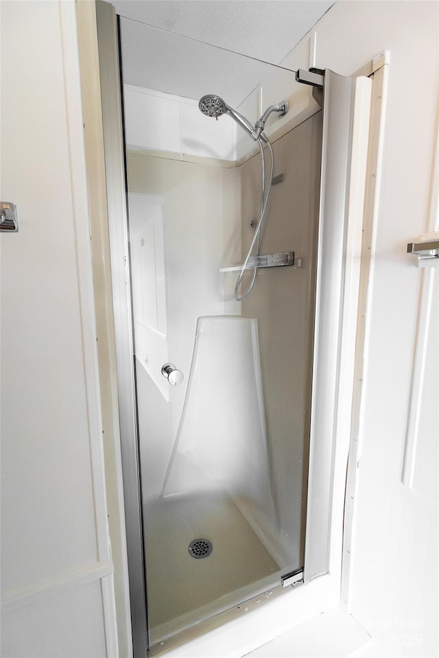 full bath featuring a shower stall