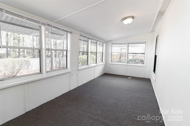unfurnished sunroom with vaulted ceiling and carpet flooring